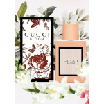 Gucci Bloom perfume bottle and box surrounded by white flowers