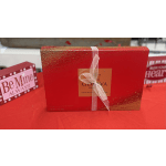 Red gift box of assorted chocolates tied with a sheer ribbon