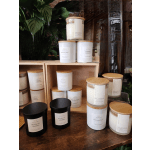 Assorted scented candles in glass jars with wooden lids