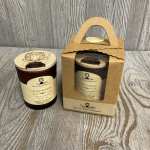 Two scented candles in glass jars, one in a cardboard gift box