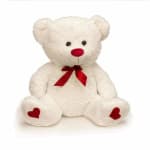 White teddy bear with a red bow and heart accents on its feet