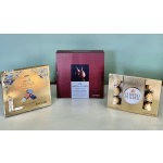 Three boxes of assorted chocolates arranged on a plain surface