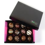 Box of assorted chocolate truffles in a black gift box