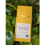 Chocolate bar in a yellow box resting on green leaves