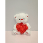 White teddy bear holding a red heart