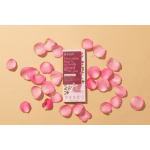 Pink rose petals scattered around a chocolate bar package