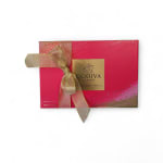Pink Godiva chocolate gift box tied with a gold ribbon