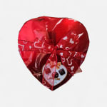 Heart-shaped box of assorted chocolates wrapped in red foil with a ribbon