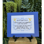 Framed cross-stitch moon-and-stars quote on a blue mat