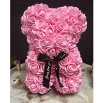 Pink teddy bear made of artificial roses with a black ribbon