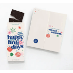 Holiday chocolate bar in festive printed packaging beside a folded card
