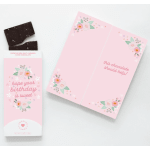 Pink greeting card and chocolate bar with floral accents