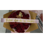 Bouquet of red roses wrapped in pink and gold paper with a butterfly topper