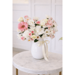 Pink and white mixed bouquet in a white vase with a ribbon