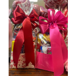 Gift bags filled with candy and topped with large satin bows