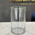 Clear cylindrical glass vase on a countertop