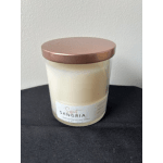 Cream-colored candle in a glass jar with a rose-gold lid