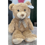 Large tan teddy bear with a checkered ribbon bow
