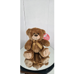 Brown teddy bear with a ribbon bow sitting on a round mirror