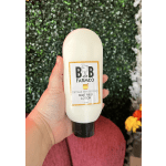 Hand holding a bottle of goat milk lotion with a farm label