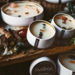 Assorted candles in white tins with crystal toppings