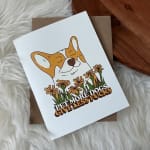 Greeting card with a cartoon dog and flowers