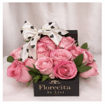 Pink roses in a black gift box with a heart-patterned bow