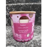 Pink scented candle in a glass jar with a wooden lid