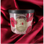 A watermelon-scented candle in a floral printed jar with a black lid