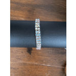 Iridescent rhinestone bracelet on a black display stand