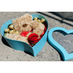 Teddy bear and chocolates in a turquoise heart-shaped box with a red rose
