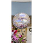 Happy Anniversary balloon above a pink and red flower bouquet
