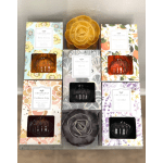 Assorted boxed home fragrance diffusers with floral designs and pumpkin-shaped glass bottles on a shelf