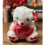 White teddy bear holding a red heart