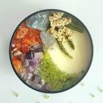 Round dish filled with colorful crystals and small white flowers
