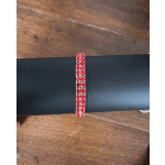 Red rhinestone bracelet on a black display stand