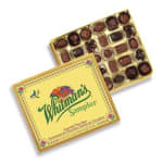 Box of assorted chocolates with a yellow floral lid