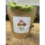 Brown paper gift bag with a green bow and floral "mom" label