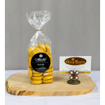 Bag of yellow chocolate candies beside a flower shop card on a wooden slab
