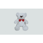 White teddy bear with a red bow tie on a plain background