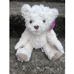White plush teddy bear with a pink nose and tag