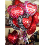 Cluster of heart-shaped Valentine's Day balloons in red, pink, and black.