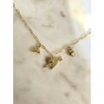 Gold charm necklace with heart and angel pendants on a marble surface