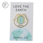 Enamel pin on a card reading "Love the Earth"