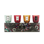 Four scented candles in colored glass holders on a decorative gift box