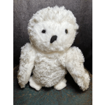 White plush teddy bear with black eyes and nose