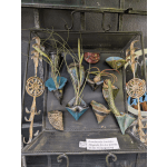 Ceramic magnets holding small air plants on a black display tray