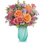 Bouquet of peach and pink roses in a turquoise vase