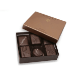 Open brown box of assorted dark chocolates with decorative toppings