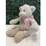Plush teddy bear with a pink ribbon bow